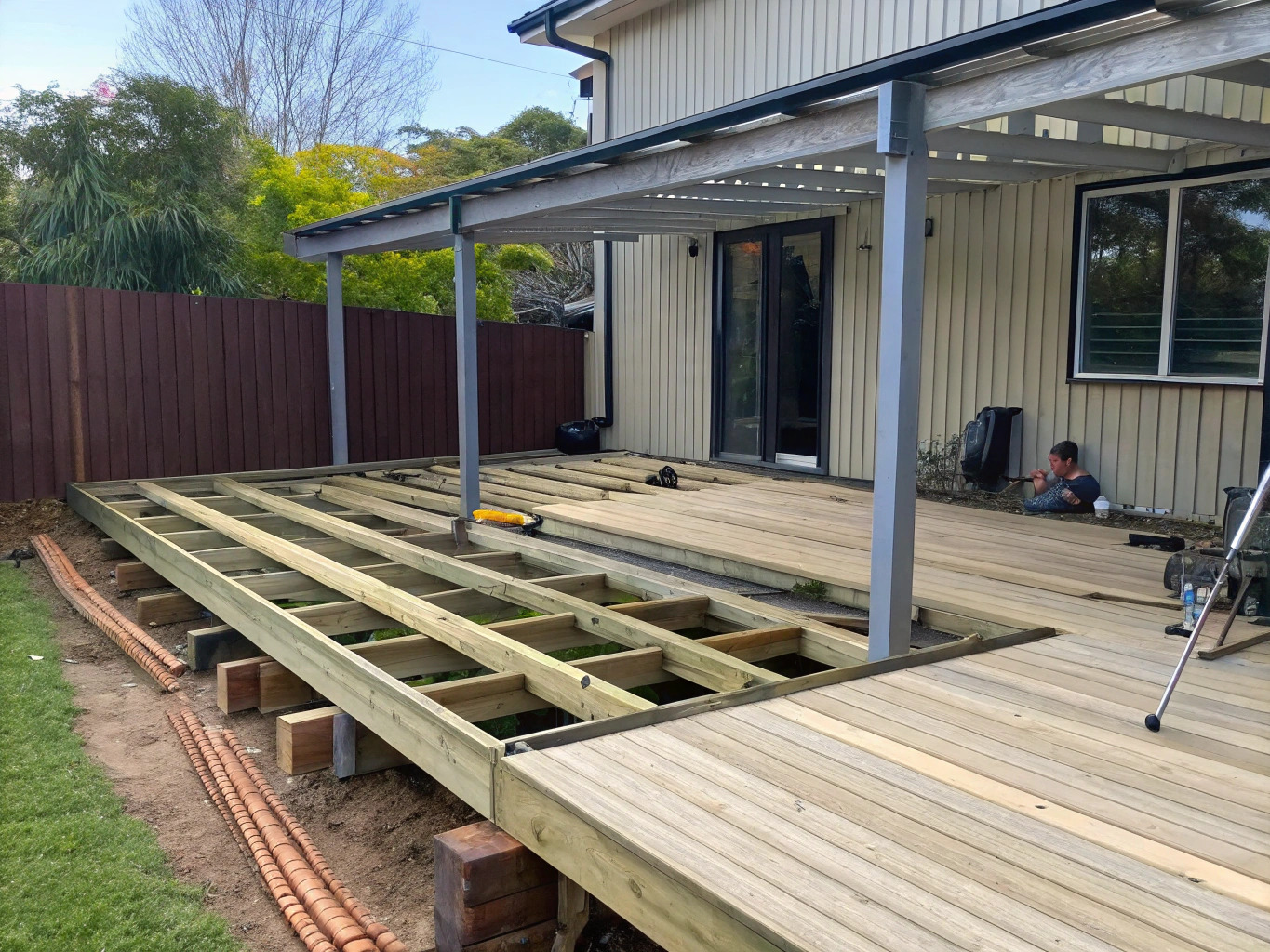 Timber deck under construction showing joists and partially laid decking boards