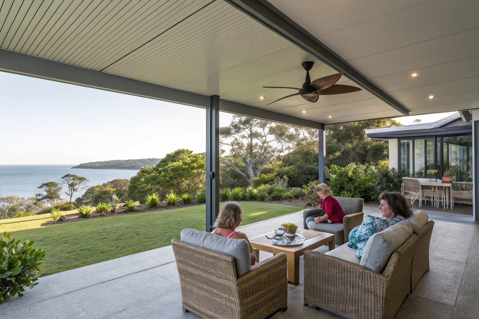 Modern patio enclosure Sunshine Coast with family entertaining in covered outdoor living space