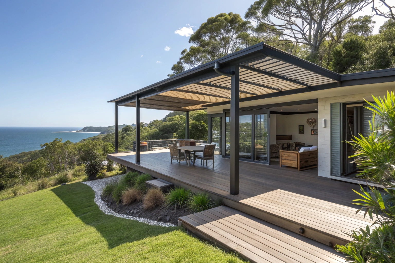 wraparound composite deck on Sunshine Coast home, modern architecture, outdoor living area with shade structure, coastal hinterland setting, lush green surroundings